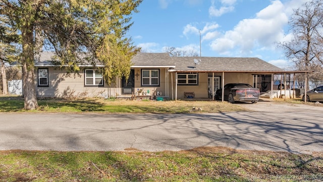 single story home with driveway and an attached carport