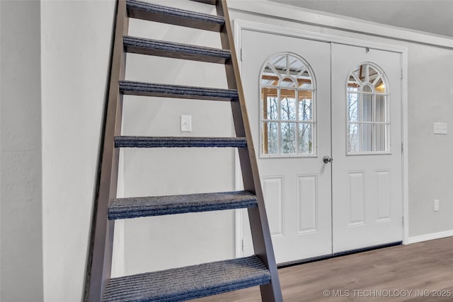 interior space featuring baseboards and wood finished floors