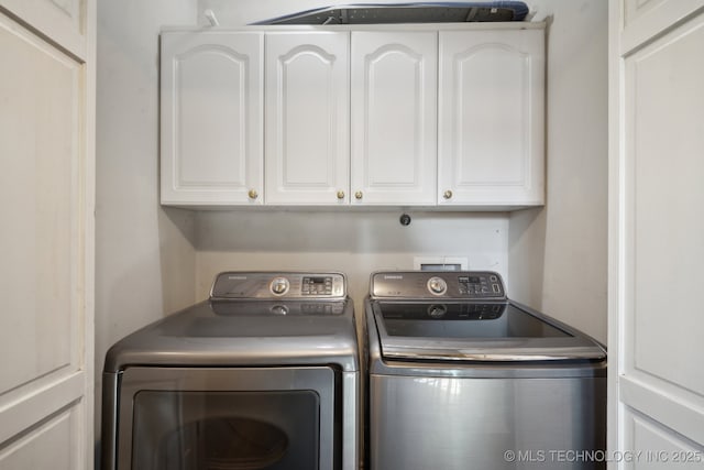 laundry room featuring cabinet space and washer and clothes dryer