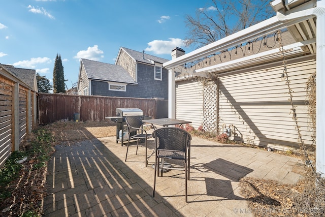 view of patio with a fenced backyard and area for grilling