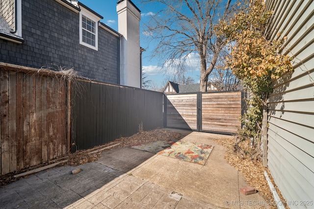 exterior space with a patio area and a fenced backyard