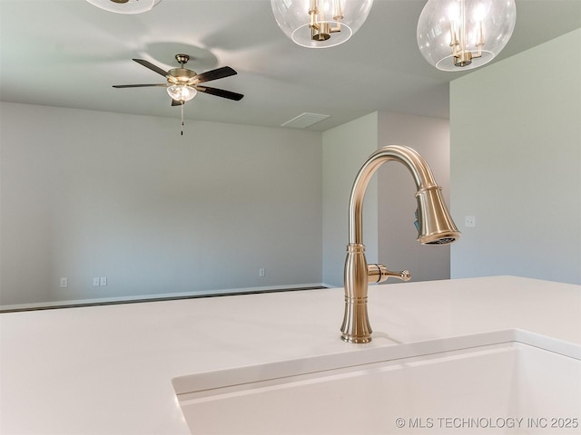 interior details featuring ceiling fan, visible vents, and a sink