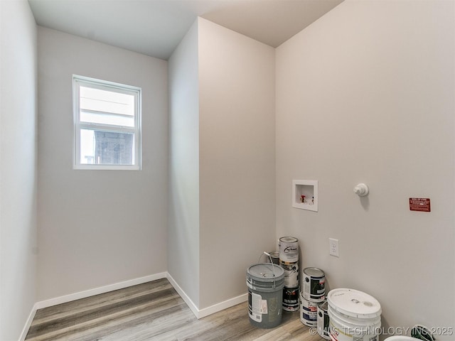 laundry area featuring laundry area, washer hookup, wood finished floors, and baseboards