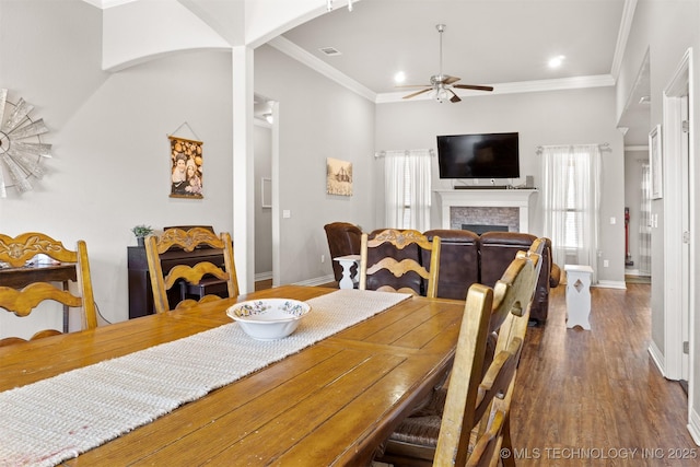 dining area with ornamental molding, dark wood finished floors, and a wealth of natural light