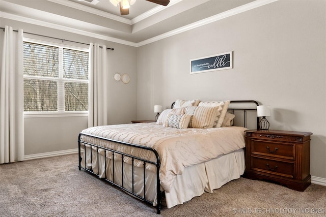 bedroom featuring light carpet, a ceiling fan, baseboards, a tray ceiling, and crown molding