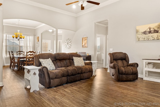 living room with arched walkways, ceiling fan with notable chandelier, baseboards, dark wood-style floors, and crown molding