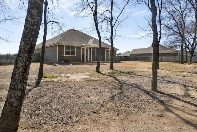 rear view of house with fence