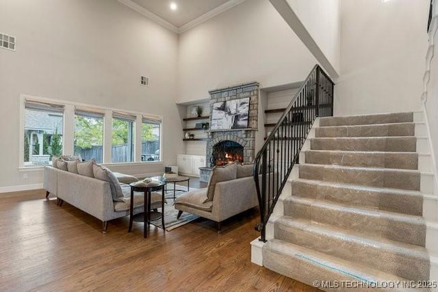 11904 S Toledo Ave, Tulsa, OK 74137 - living area featuring visible vents, ornamental molding, wood finished floors, baseboards, and stairs