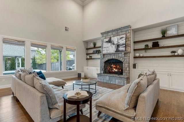 11904 S Toledo Ave, Tulsa, OK 74137 - living room featuring a stone fireplace, a towering ceiling, visible vents, baseboards, and dark wood-style floors