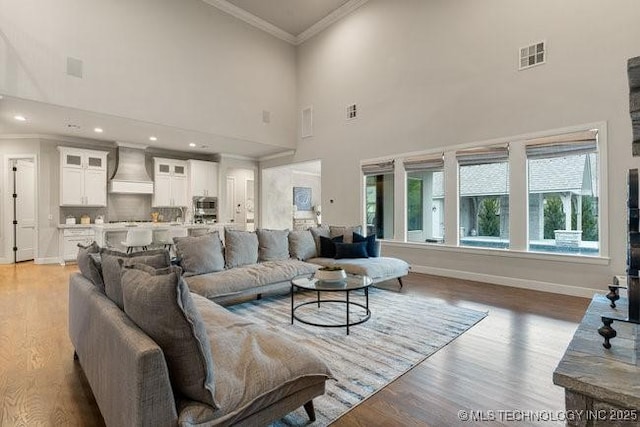 11904 S Toledo Ave, Tulsa, OK 74137 - living area with recessed lighting, visible vents, light wood-style flooring, ornamental molding, and baseboards