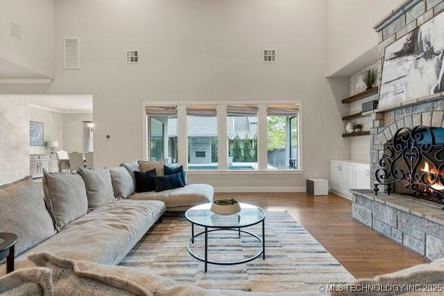 11904 S Toledo Ave, Tulsa, OK 74137 - living room featuring visible vents, a fireplace, baseboards, and wood finished floors