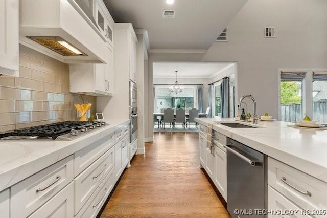 11904 S Toledo Ave, Tulsa, OK 74137 - kitchen featuring stainless steel appliances, white cabinetry, glass insert cabinets, and custom exhaust hood
