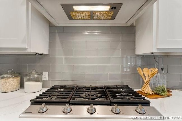 11904 S Toledo Ave, Tulsa, OK 74137 - kitchen featuring stainless steel gas stovetop, tasteful backsplash, wall chimney exhaust hood, and white cabinets