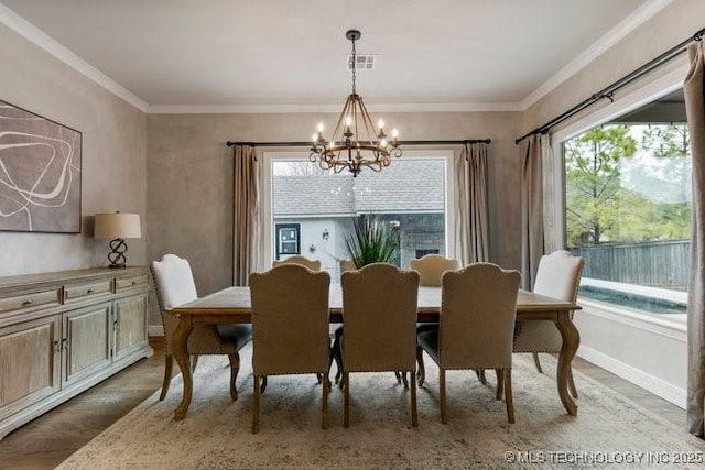 11904 S Toledo Ave, Tulsa, OK 74137 - dining room featuring visible vents, baseboards, ornamental molding, wood finished floors, and a chandelier