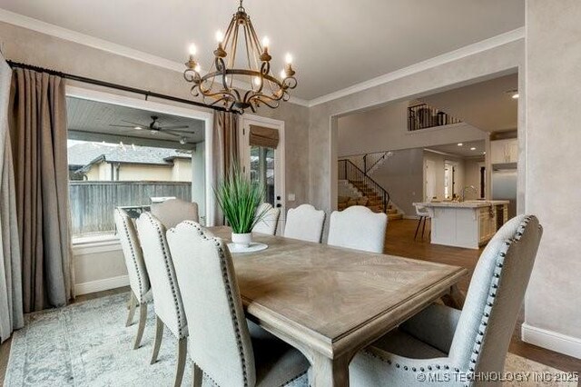 11904 S Toledo Ave, Tulsa, OK 74137 - dining space with baseboards, light wood-style flooring, ornamental molding, stairs, and ceiling fan with notable chandelier