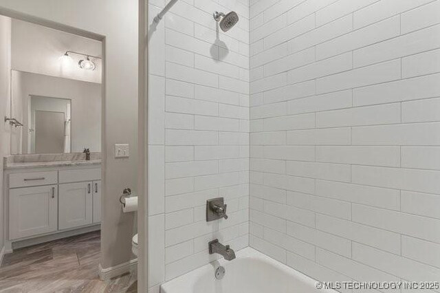 11904 S Toledo Ave, Tulsa, OK 74137 - full bathroom with shower / washtub combination, vanity, toilet, and wood finished floors