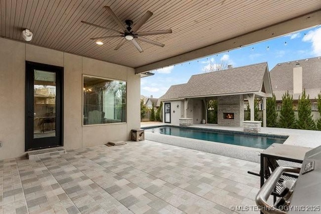 11904 S Toledo Ave, Tulsa, OK 74137 - view of pool featuring a ceiling fan, an outdoor stone fireplace, and a patio area