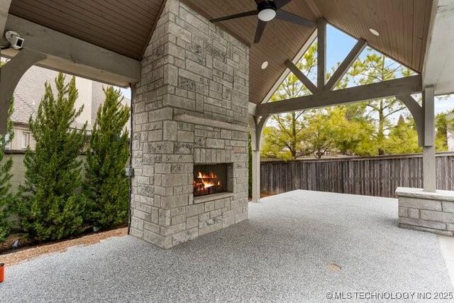 11904 S Toledo Ave, Tulsa, OK 74137 - view of patio / terrace with ceiling fan, fence, and an outdoor stone fireplace