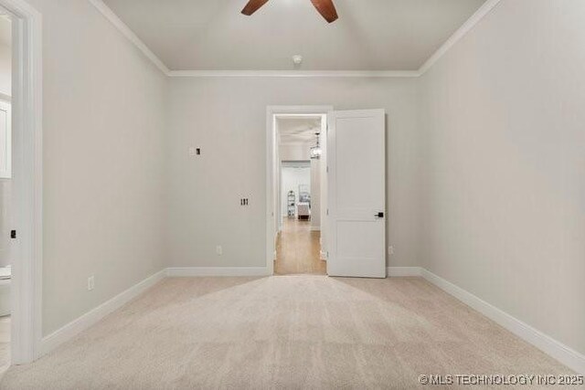 11904 S Toledo Ave, Tulsa, OK 74137 - spare room featuring light carpet, baseboards, and crown molding