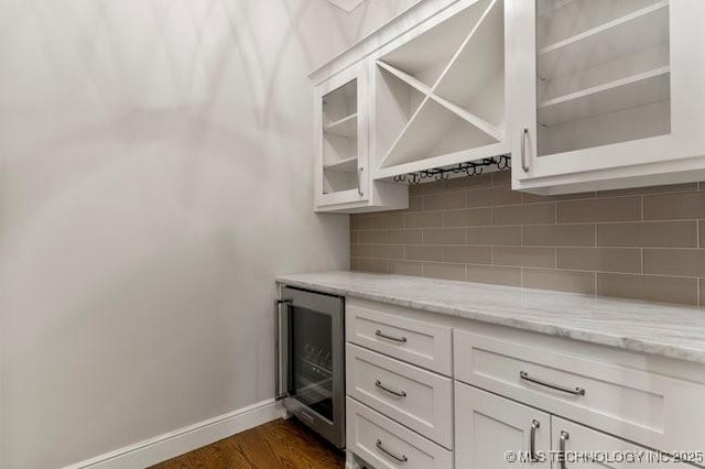 11904 S Toledo Ave, Tulsa, OK 74137 - bar with wine cooler, dark wood finished floors, backsplash, a bar, and baseboards