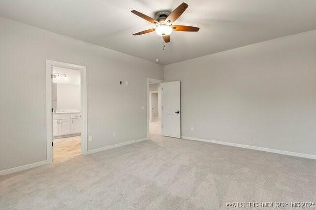 11904 S Toledo Ave, Tulsa, OK 74137 - unfurnished bedroom featuring baseboards, ensuite bathroom, a ceiling fan, and light colored carpet