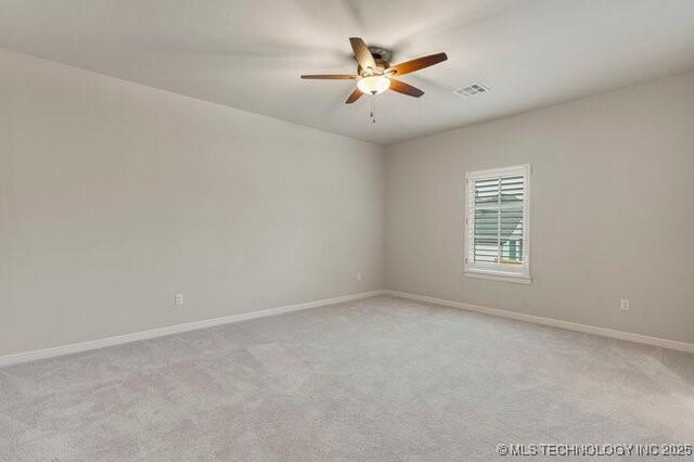 11904 S Toledo Ave, Tulsa, OK 74137 - unfurnished room featuring light colored carpet, visible vents, ceiling fan, and baseboards