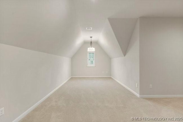 11904 S Toledo Ave, Tulsa, OK 74137 - additional living space featuring lofted ceiling, baseboards, visible vents, and light colored carpet