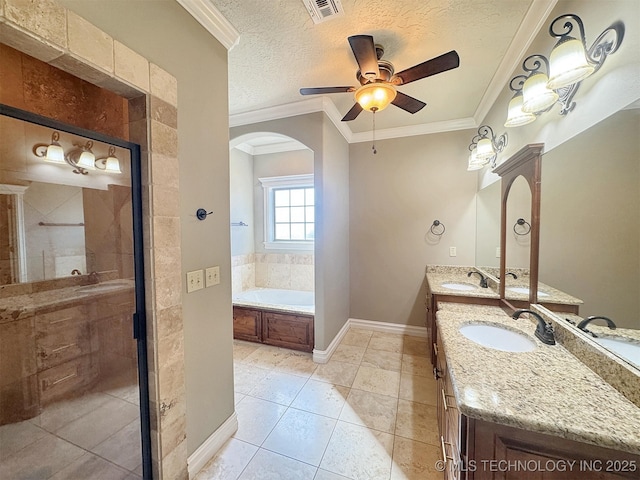 bathroom featuring a garden tub, crown molding, a textured ceiling, and a sink