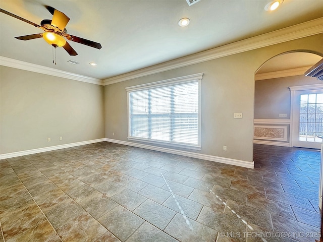 unfurnished room with baseboards, visible vents, arched walkways, a ceiling fan, and crown molding