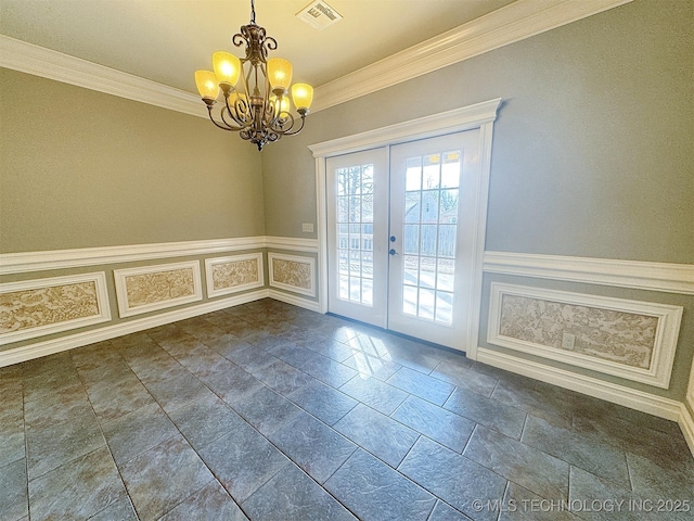 interior space with french doors, a wainscoted wall, visible vents, a decorative wall, and ornamental molding