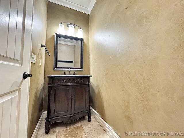 bathroom featuring ornamental molding, tile patterned floors, vanity, and baseboards