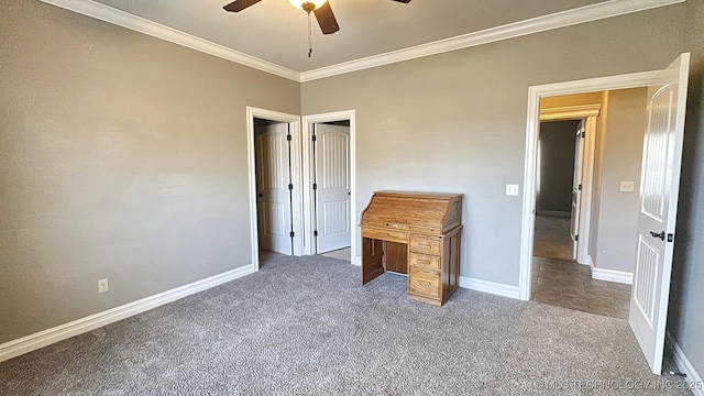 unfurnished bedroom featuring carpet floors, a ceiling fan, baseboards, and crown molding