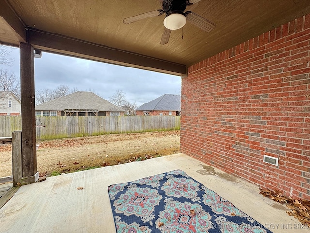 view of patio featuring a ceiling fan and fence