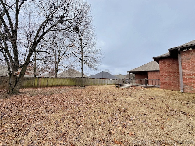 view of yard with a fenced backyard and a deck