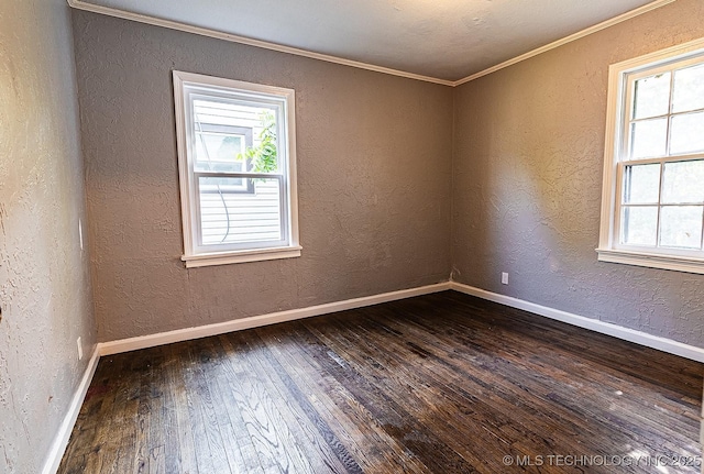 unfurnished room featuring dark wood-style flooring, a healthy amount of sunlight, a textured wall, and baseboards