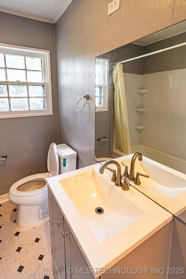 bathroom with crown molding, toilet, shower / tub combo, wooden walls, and vanity