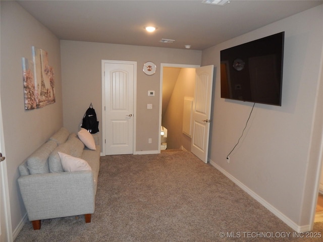 sitting room with visible vents, baseboards, and carpet