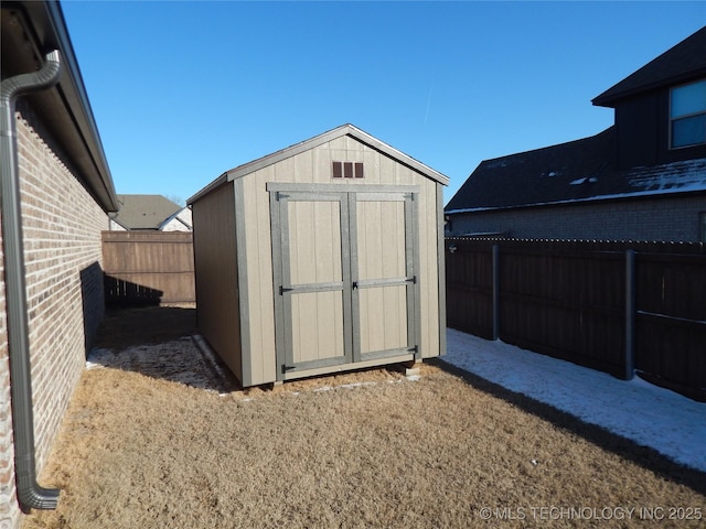 view of shed with a fenced backyard