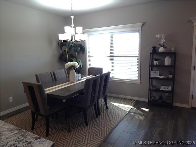 dining area with an inviting chandelier, wood finished floors, and baseboards