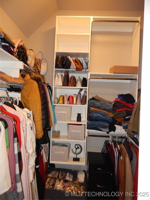 walk in closet with lofted ceiling