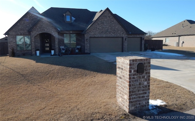 view of front of property featuring concrete driveway, an attached garage, and brick siding