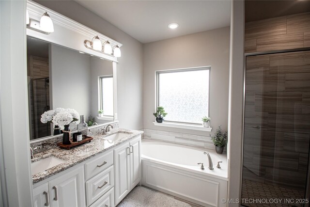 190 N Castle St, Skiatook, OK 74070 - bathroom featuring double vanity, a stall shower, and a bath