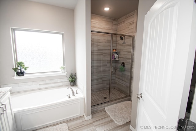 190 N Castle St, Skiatook, OK 74070 - full bathroom featuring a garden tub, a shower stall, vanity, and recessed lighting
