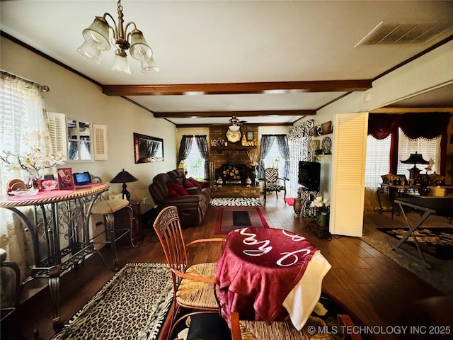 dining room with beam ceiling, a fireplace, visible vents, and a healthy amount of sunlight