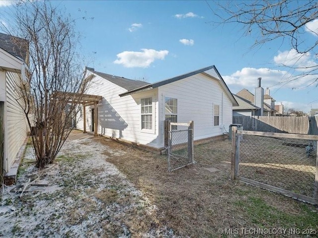 view of side of property with a gate, fence, and a pergola