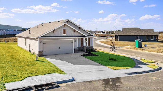 view of front of property featuring a garage, driveway, and a front lawn