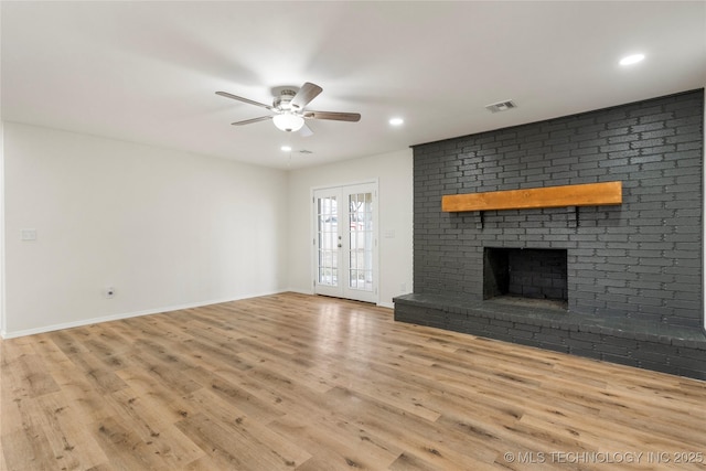 unfurnished living room featuring ceiling fan, light wood-style flooring, a fireplace, baseboards, and french doors