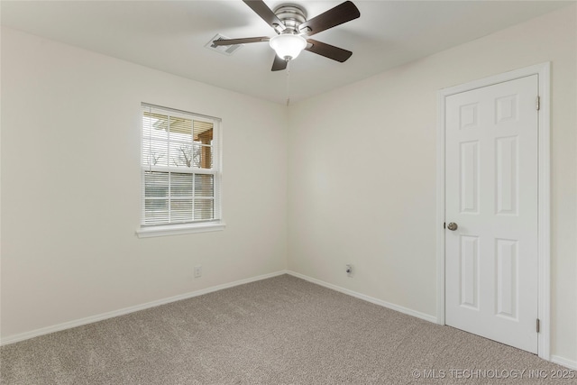 empty room featuring carpet floors, ceiling fan, and baseboards