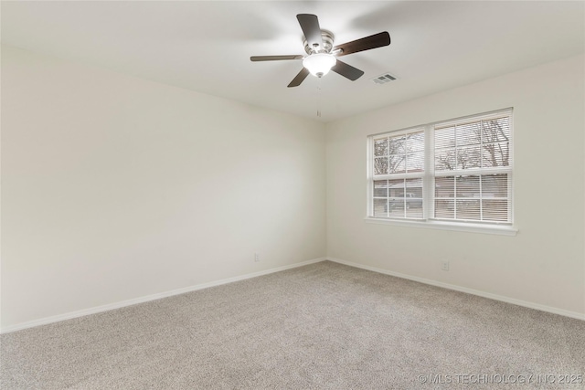 unfurnished room with carpet floors, visible vents, baseboards, and ceiling fan