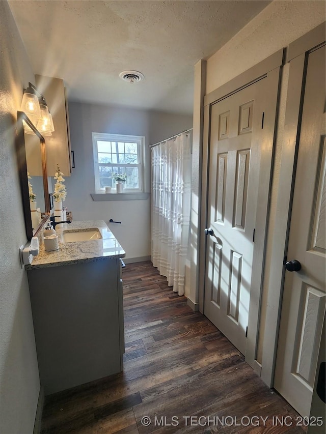 150 Birch Rd, Ardmore, OK 73401 - bathroom featuring visible vents, vanity, wood finished floors, baseboards, and a shower with curtain